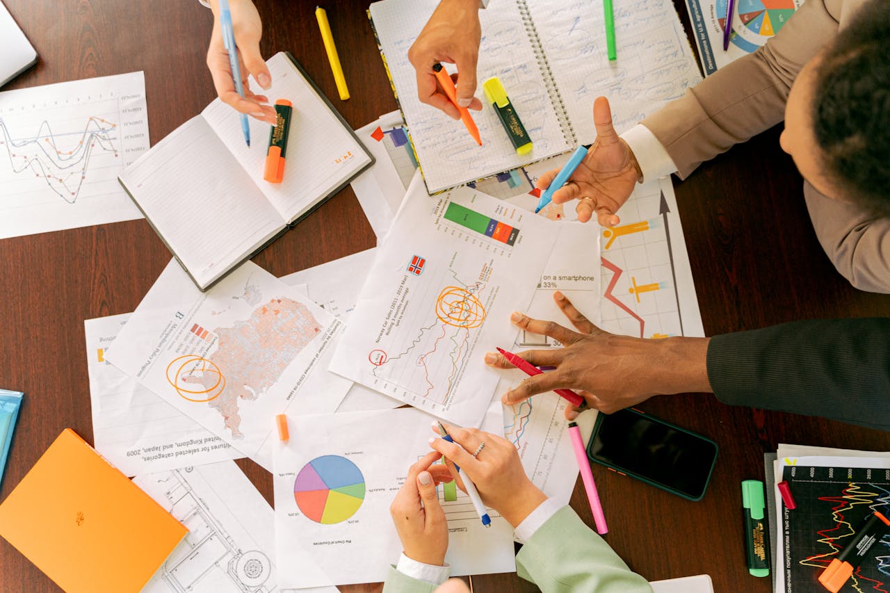 services-02 Business professionals collaborating over charts and data in a conference room.